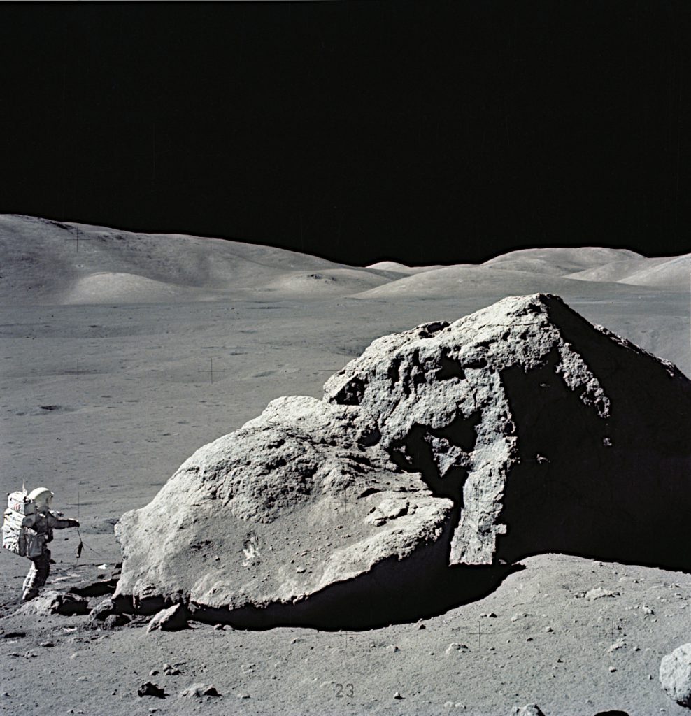 最後の月着陸ミッション、アポロ17号で月面の巨岩の横に立つ飛行士