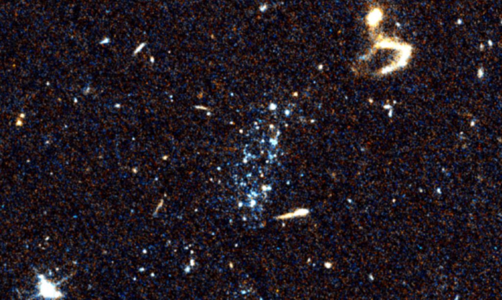 画像中央に見られるような、若く青い星の集団が銀河間空間で見つかりました。画像はハッブル宇宙望遠鏡のACS（掃天観測用高性能カメラ）で撮影。（Michael Jones氏提供）