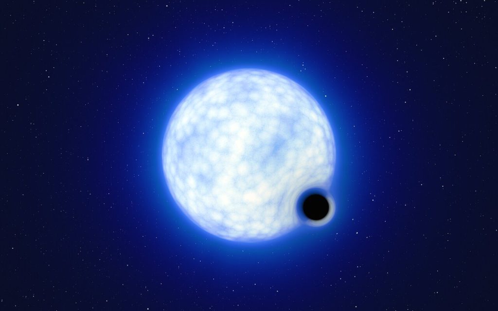 連星系VFTS 243の想像図。ブラックホールは実際の比率より大きく描かれています。青い星は実際にはブラックホールの約20万倍の大きさです。