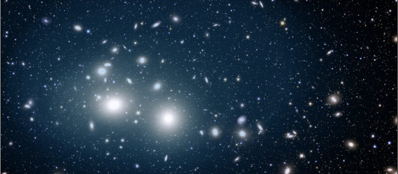 ユークリッド宇宙望遠鏡がとらえた、ペルセウス座銀河団の銀河間光。ぼんやりと青く輝いているのが銀河間光です。迷子星は銀河団全体に散らばっており、銀河団の中心から最大200万光年まで広がっています。Image Credit: ESA/Euclid/Euclid Consortium/NASA, image processing by M. Montes (IAC) and J.-C. Cuillandre (CEA Paris-Saclay)